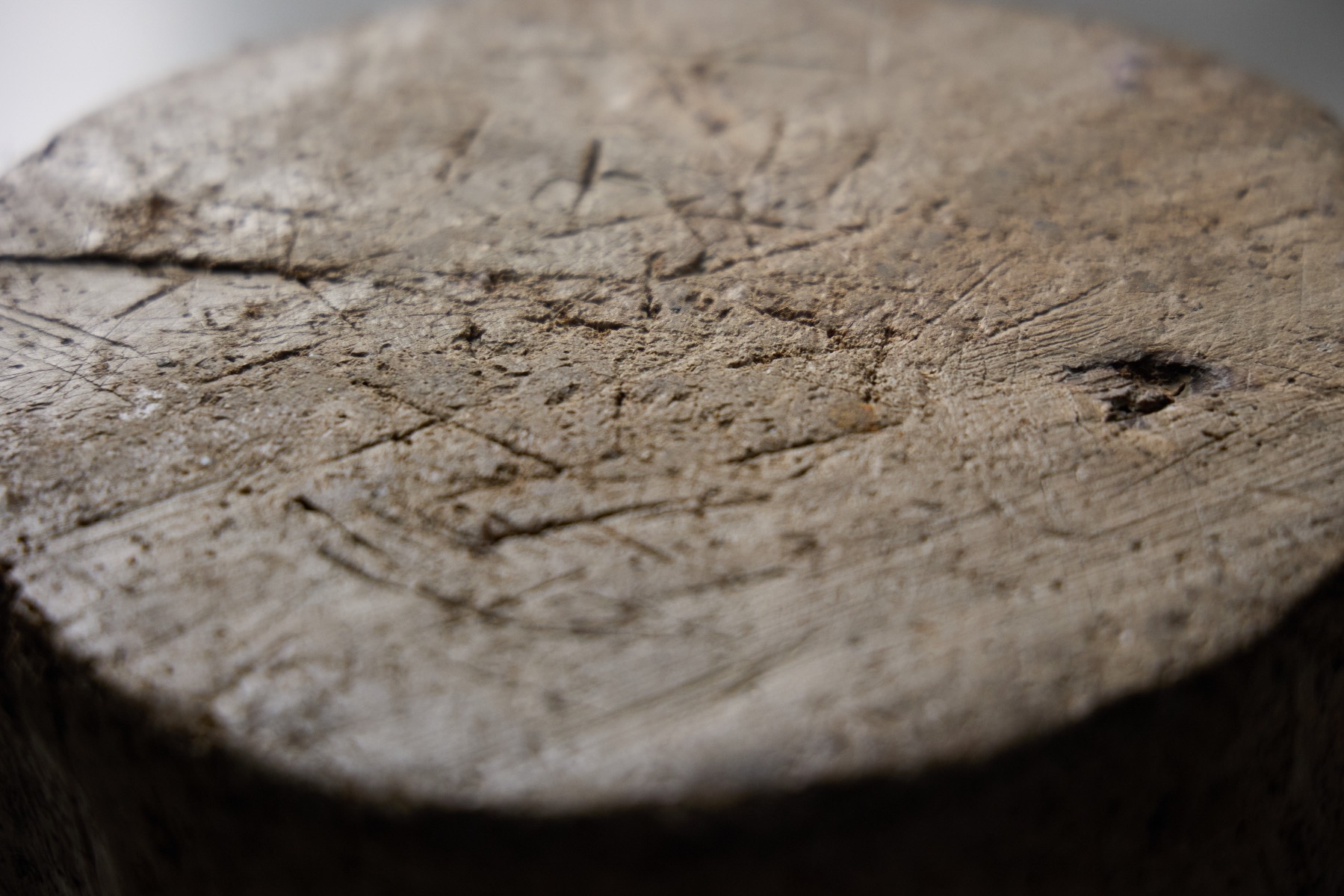 Primitive solid wood stool with timeworn surface