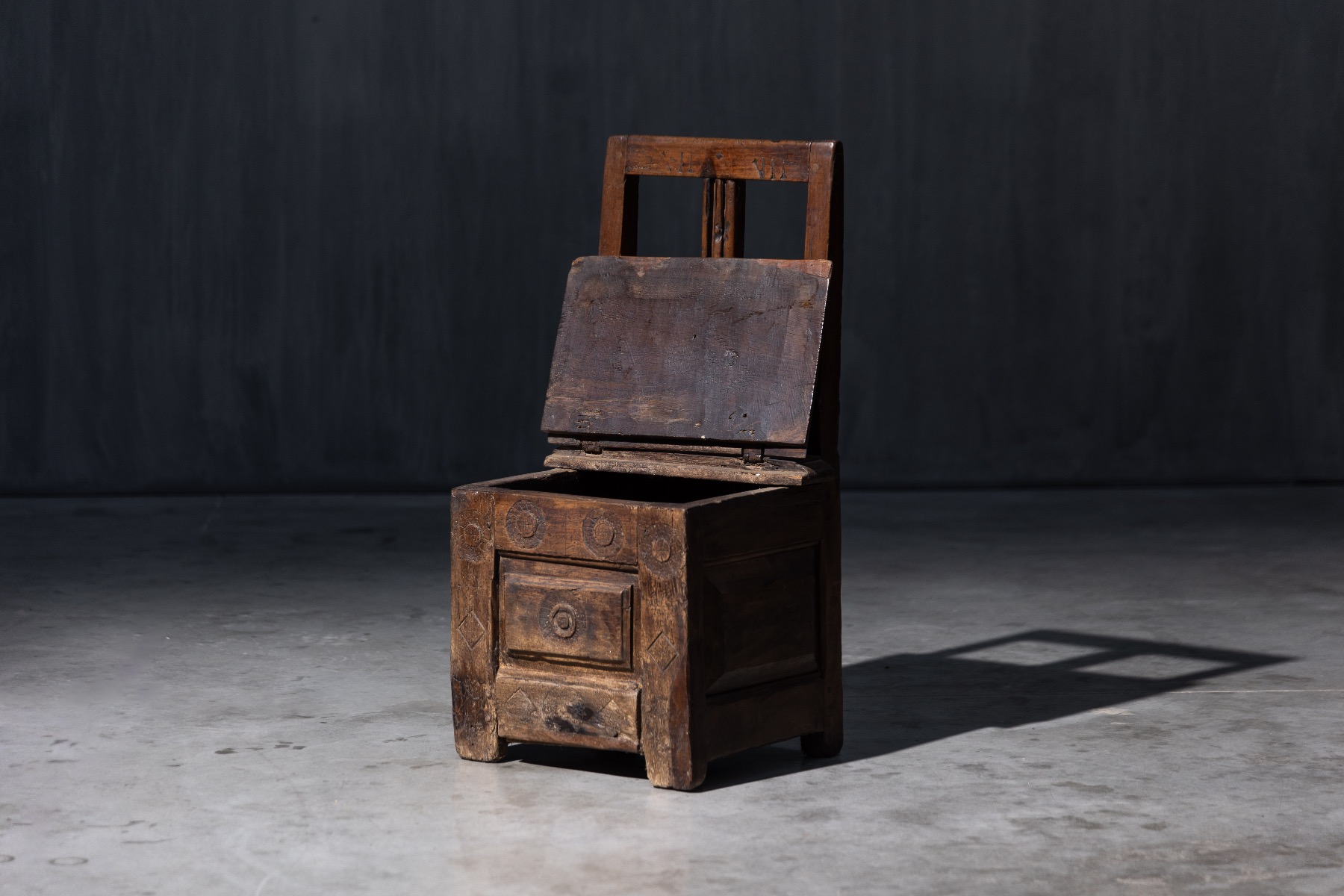 Primitive handcrafted storage chair in solid wood