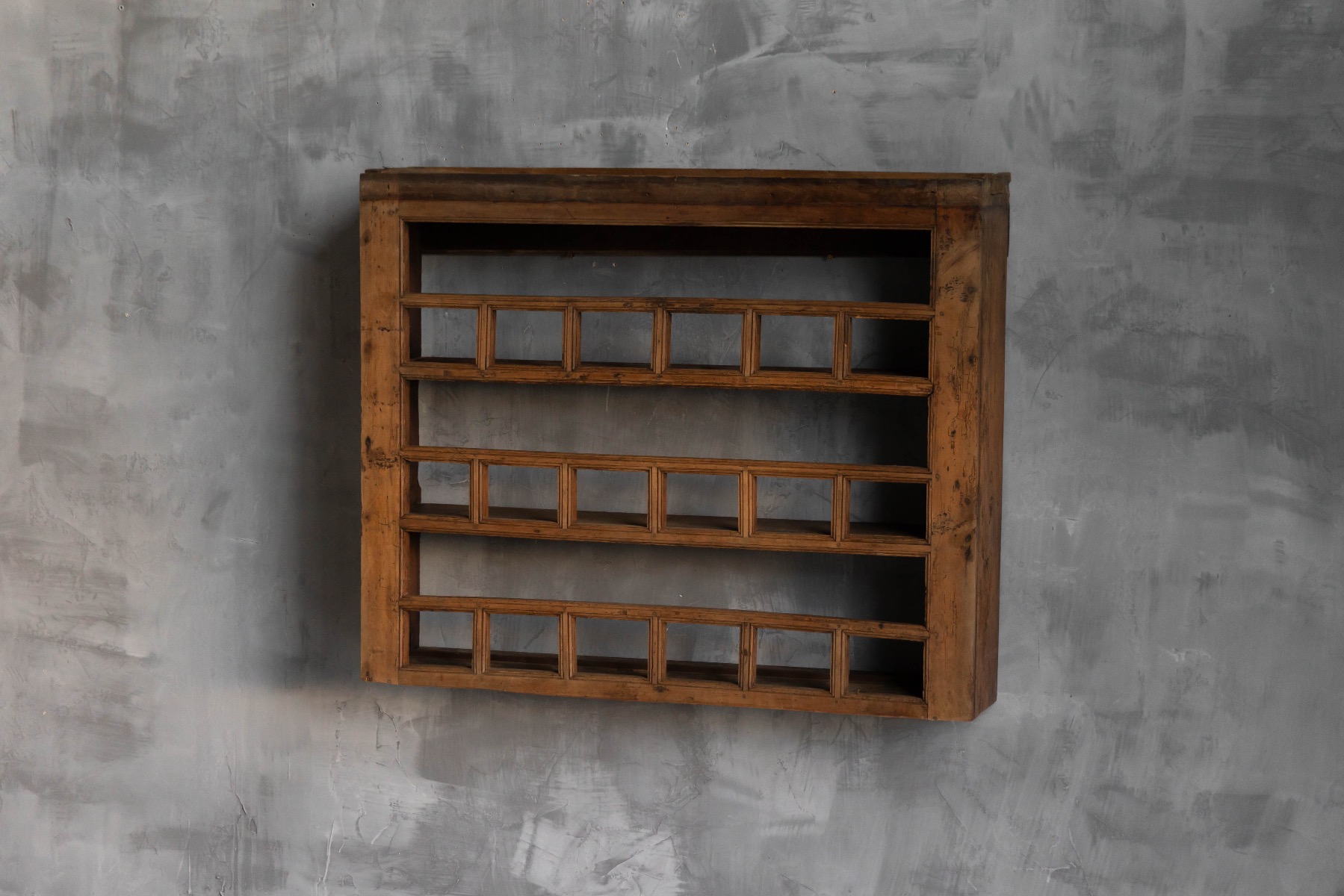 Primitive wooden wall mounted shelf from the 19th century