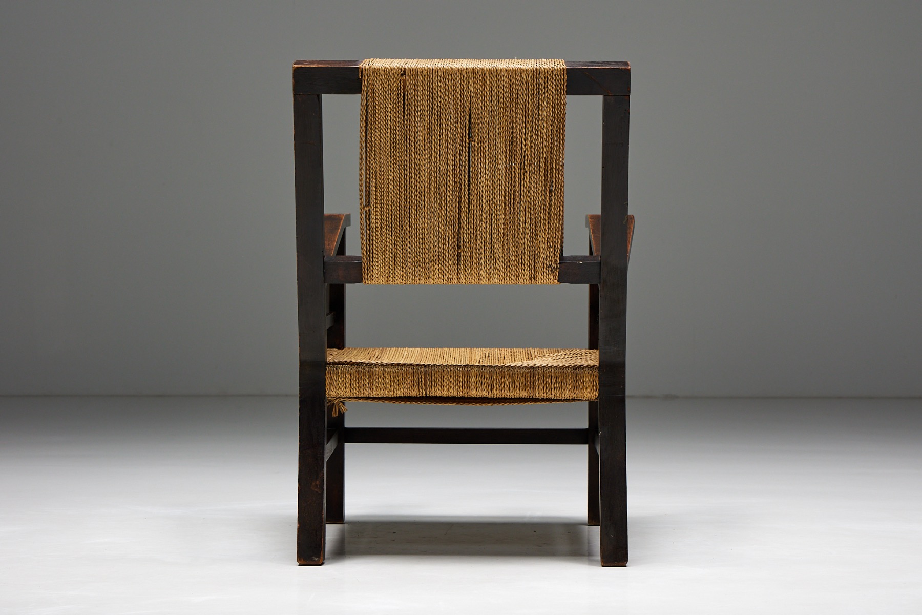 Rustic easy chair with wood frame and rope seat