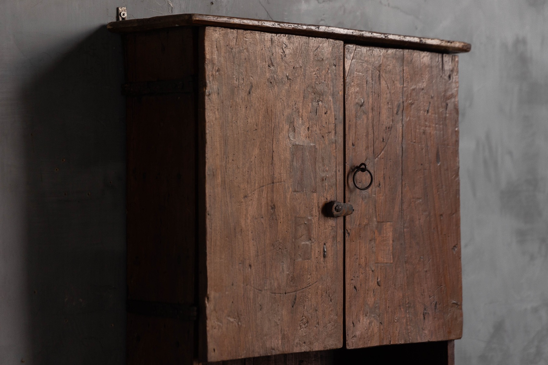 Rustic vernacular wall cabinet with utilitarian design