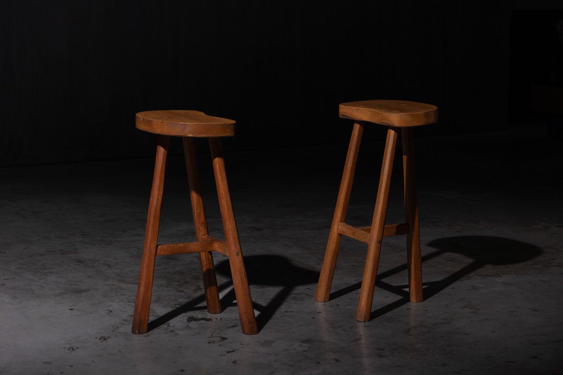 Handcrafted wooden bar stools with aged patina