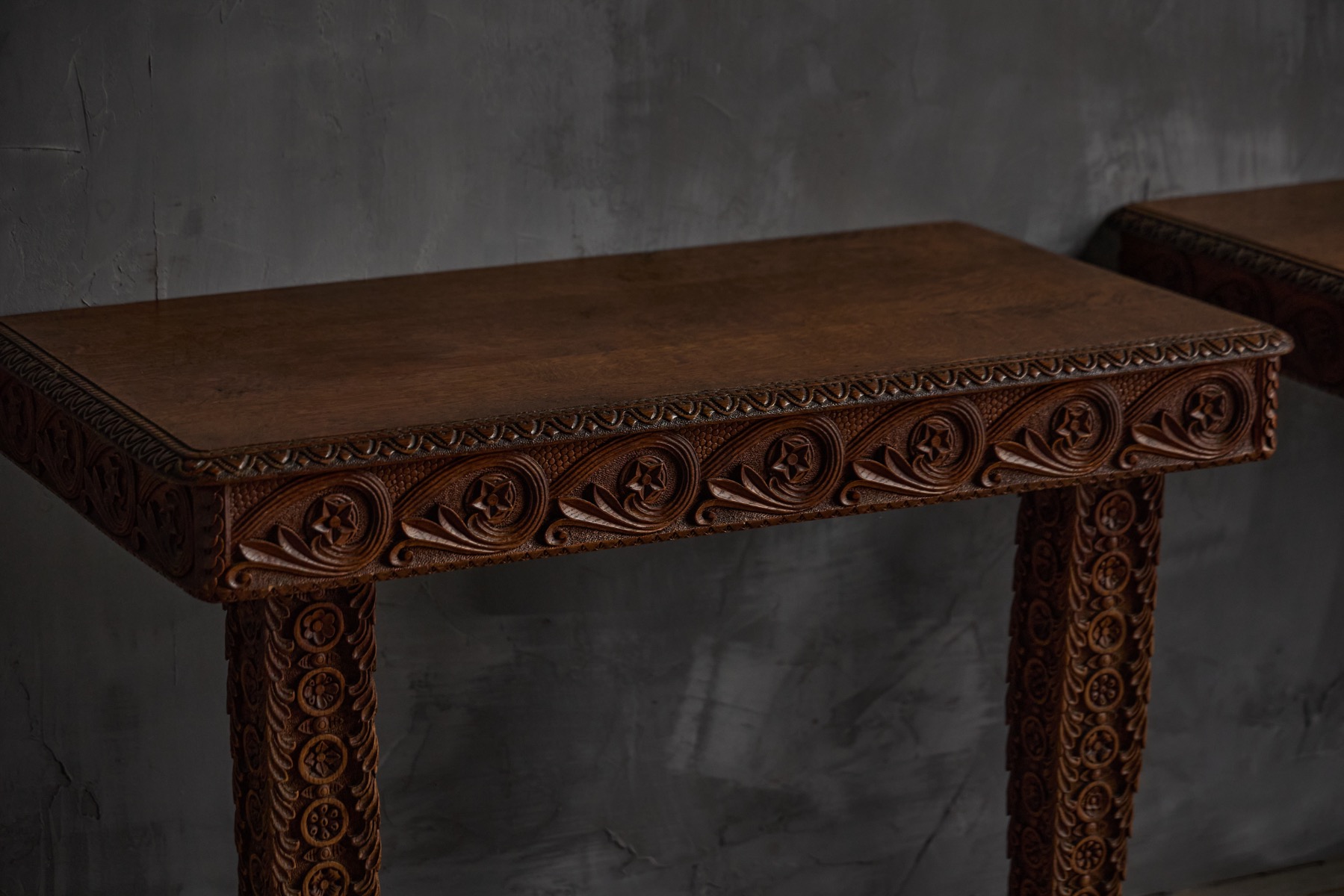 Decorative antique console table in carved wood with historic detailing