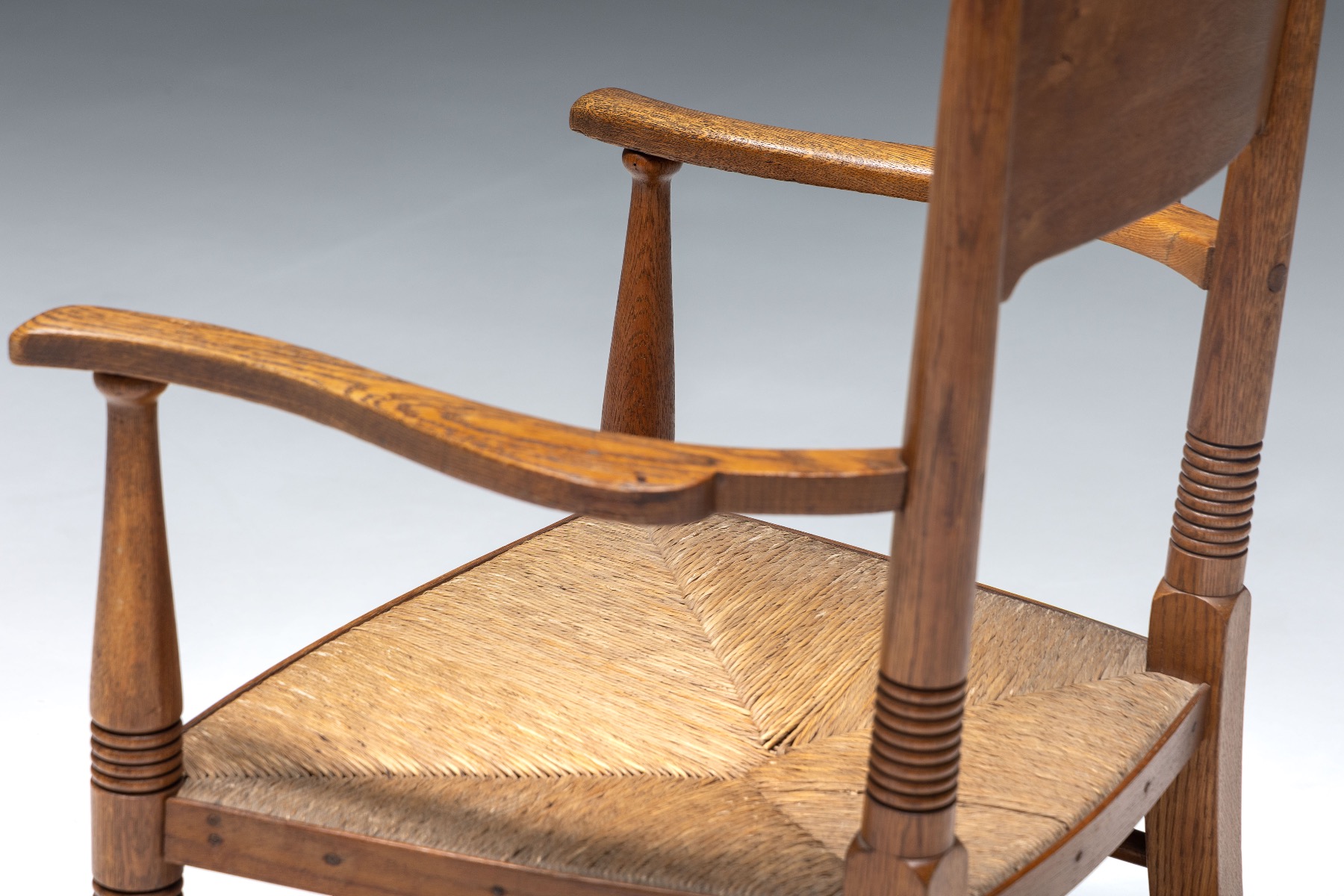 Handcrafted oak armchair with straw seat design