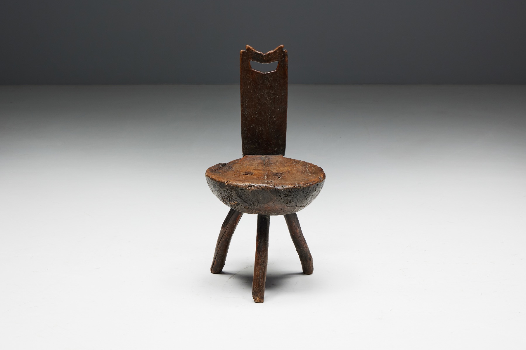 Handcrafted tripod chairs in rustic alpine wood