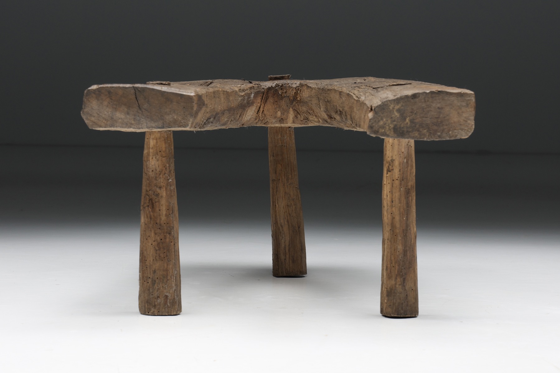 Handcrafted wabi sabi tripod stool in solid wood