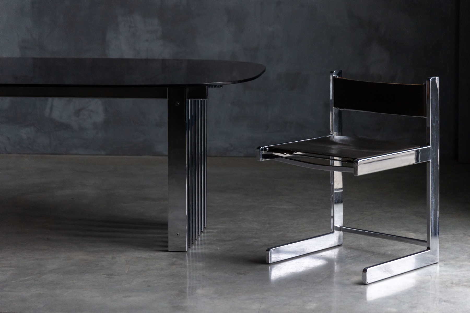 Sculptural chrome base dining table