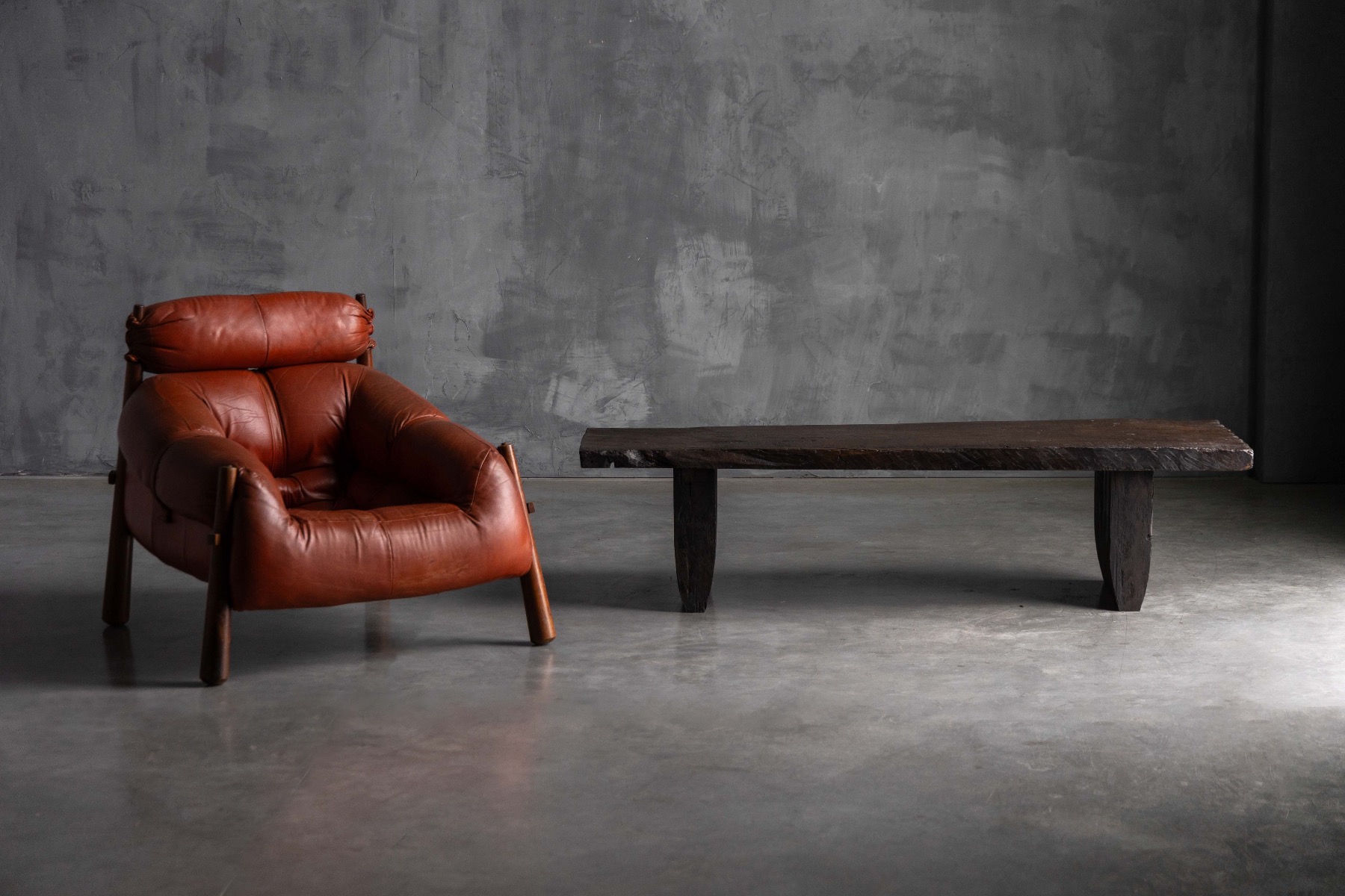 Primitive rustic coffee table with heavy brutalist proportions