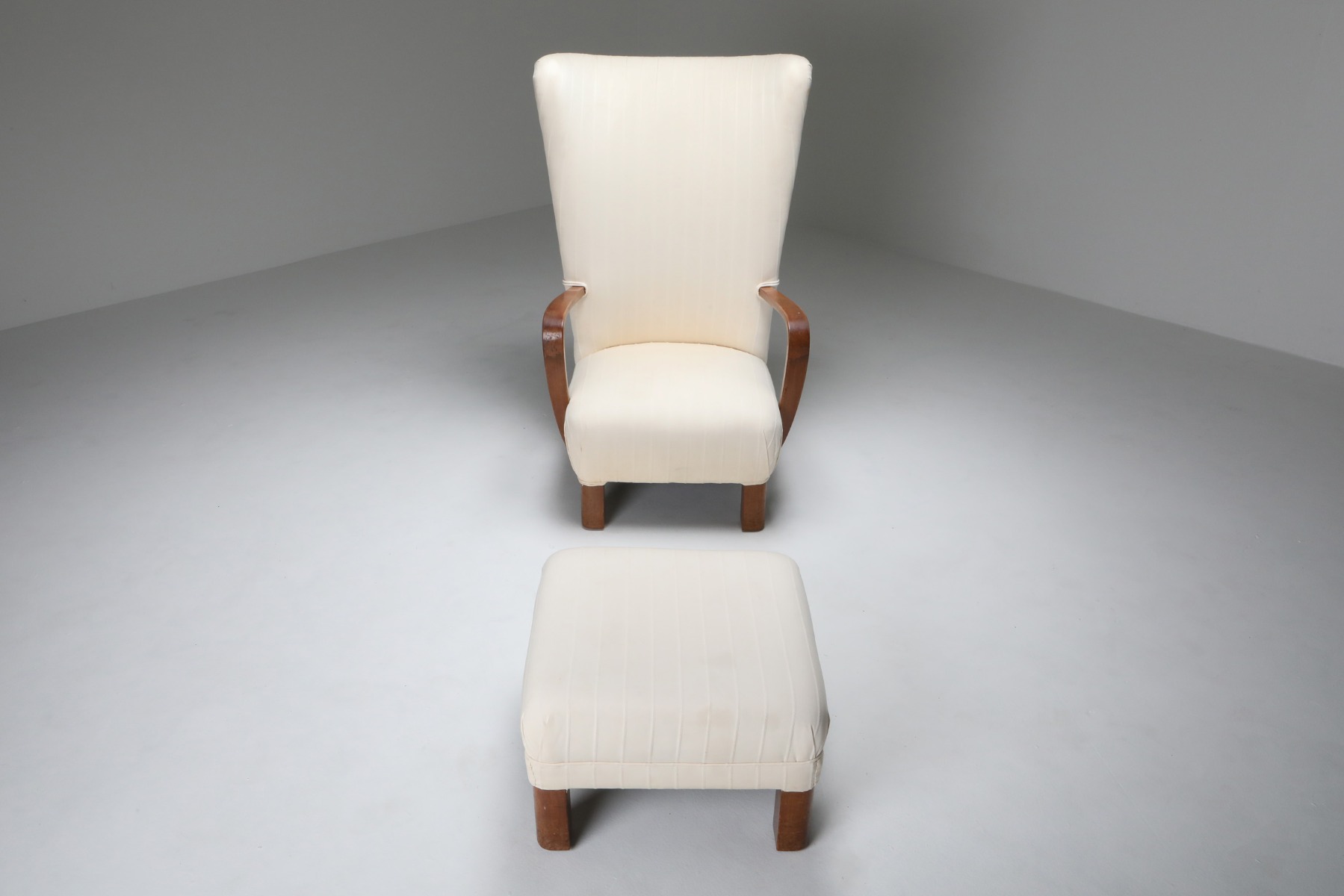 Retro white wingback chair with ottoman from the 1950s