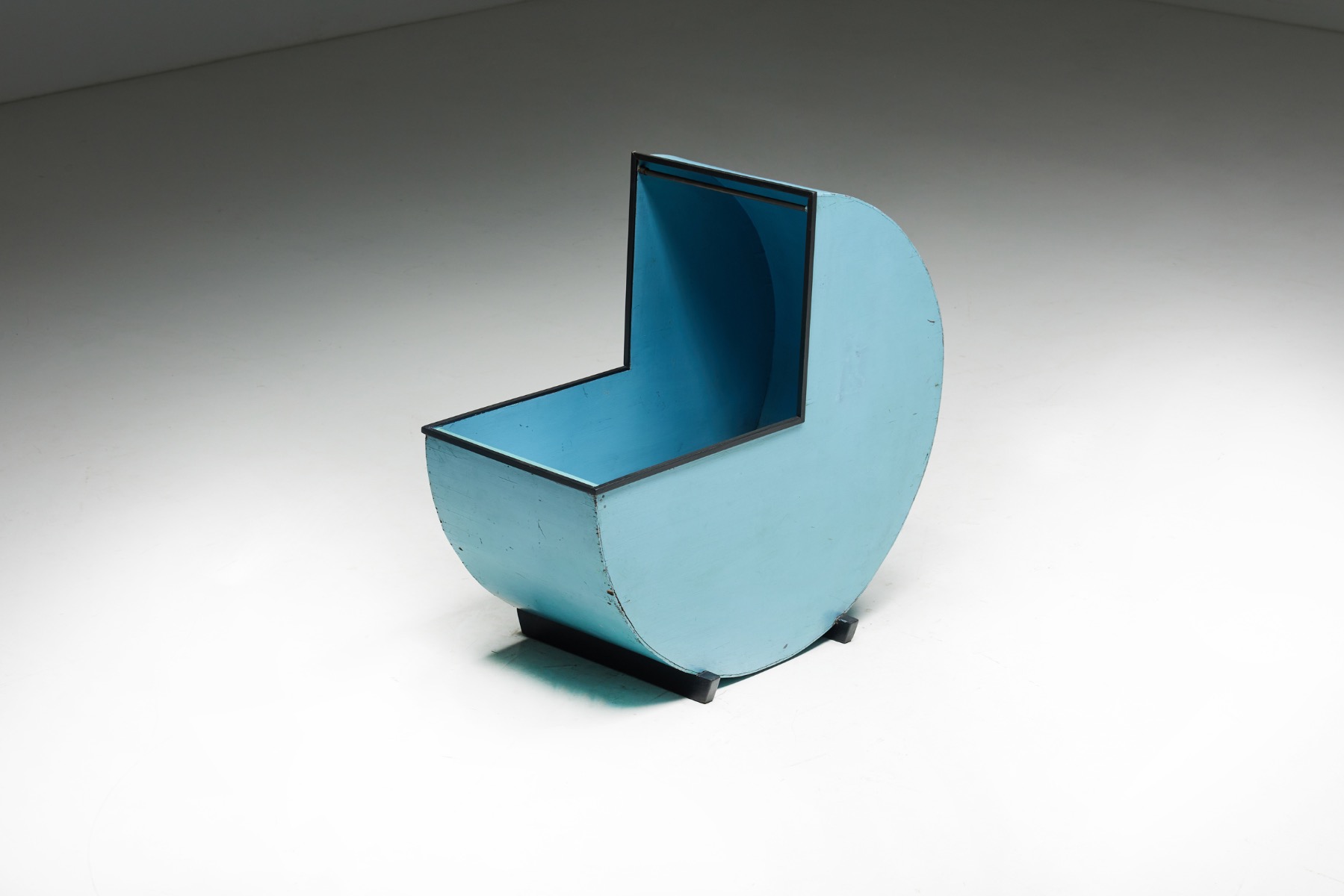 Rustic blue painted wood cradle in round form