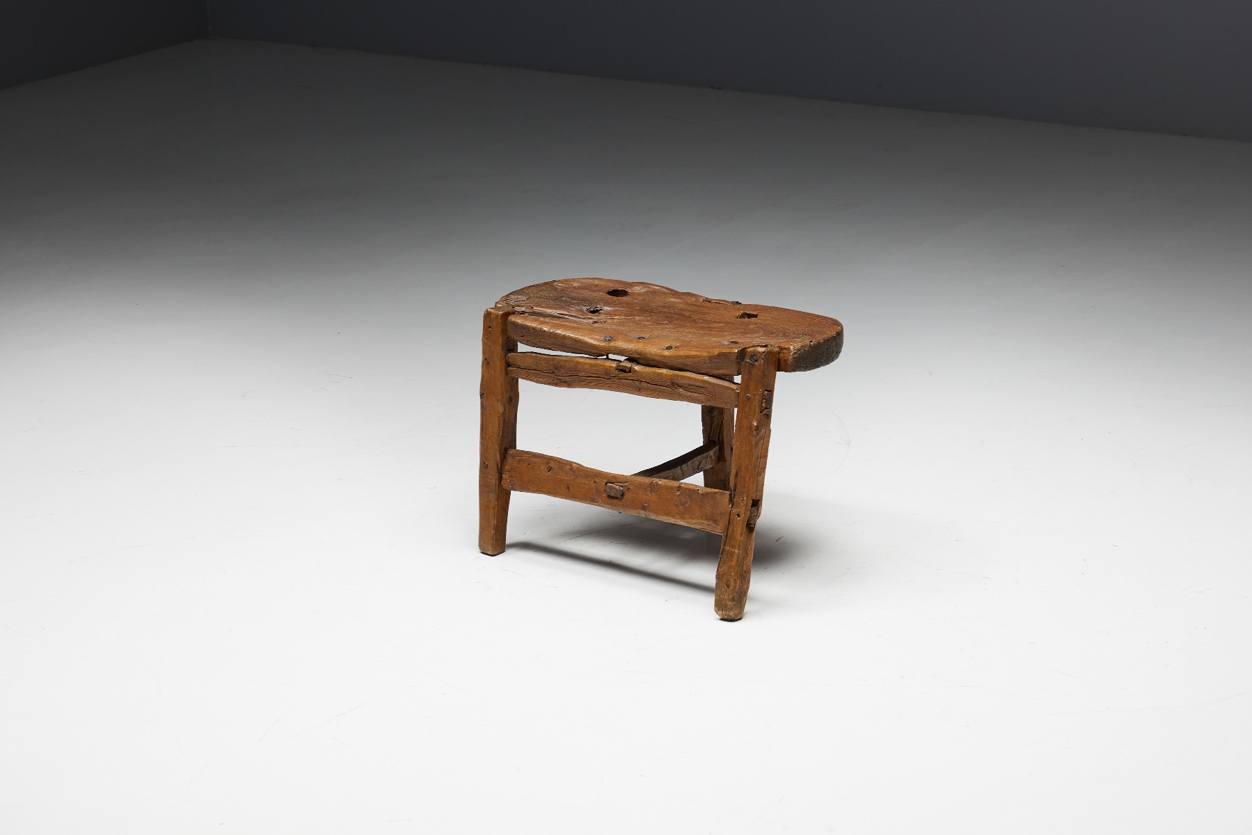 Rustic three leg bench in organic wood