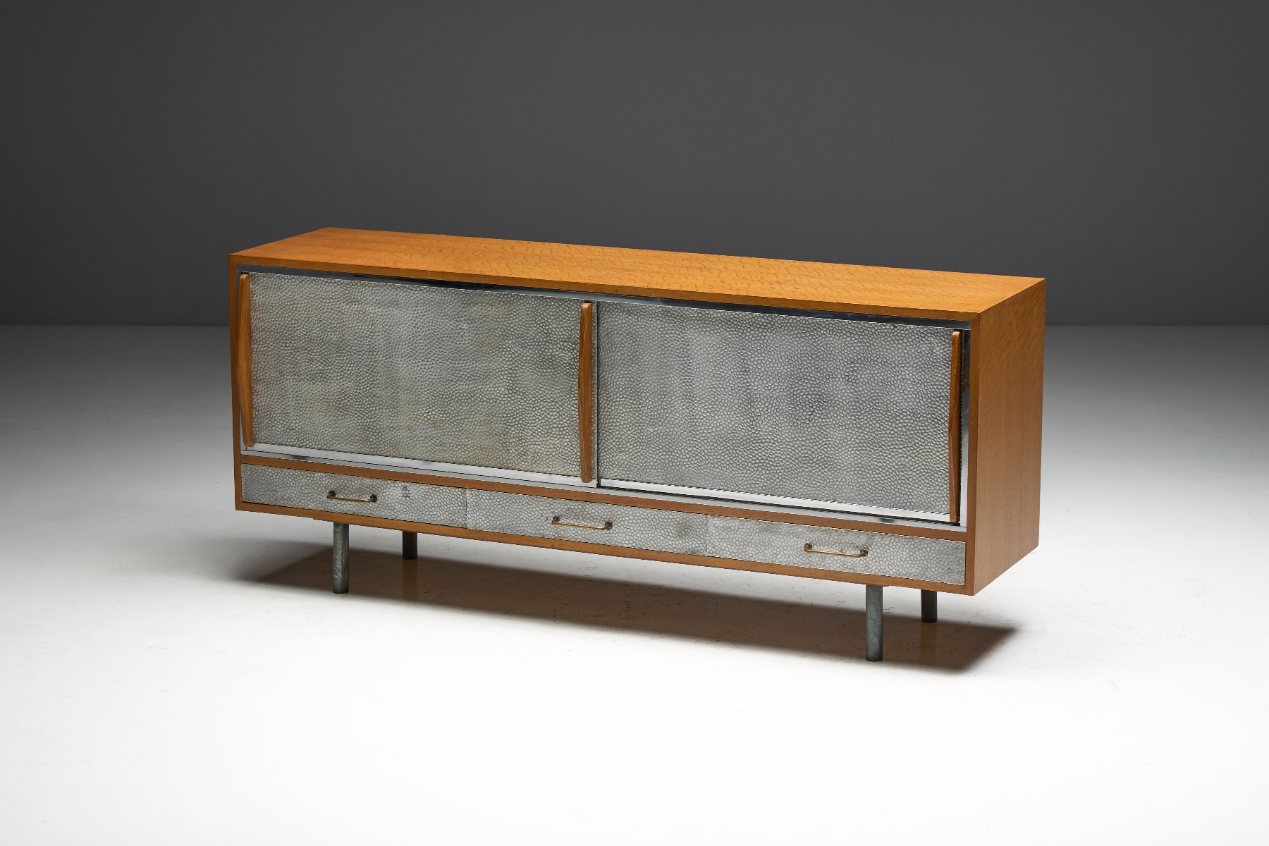 Sculptural mid century sideboard with hammered metal surface