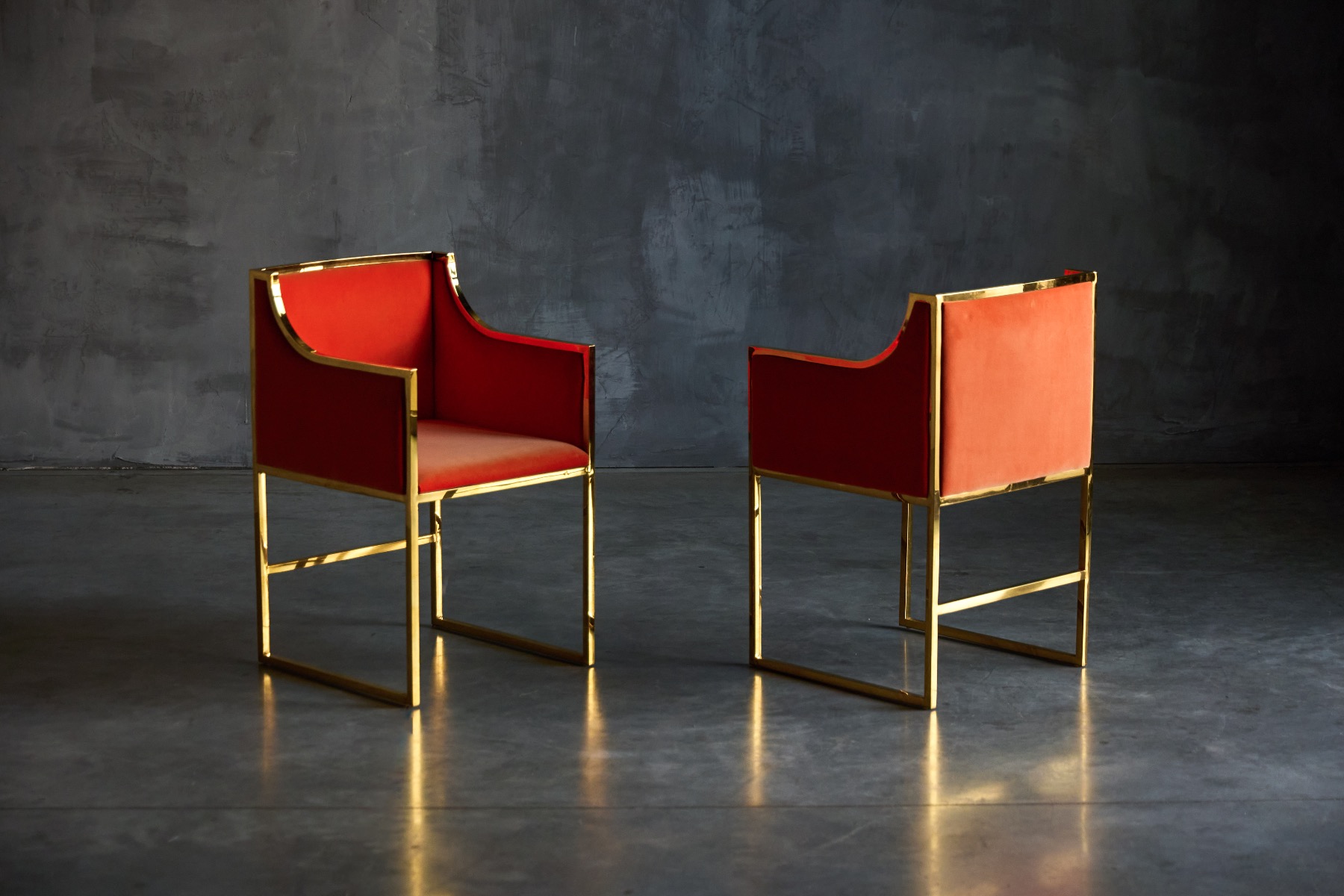 Sculptural brass armchairs with orange velvet upholstery