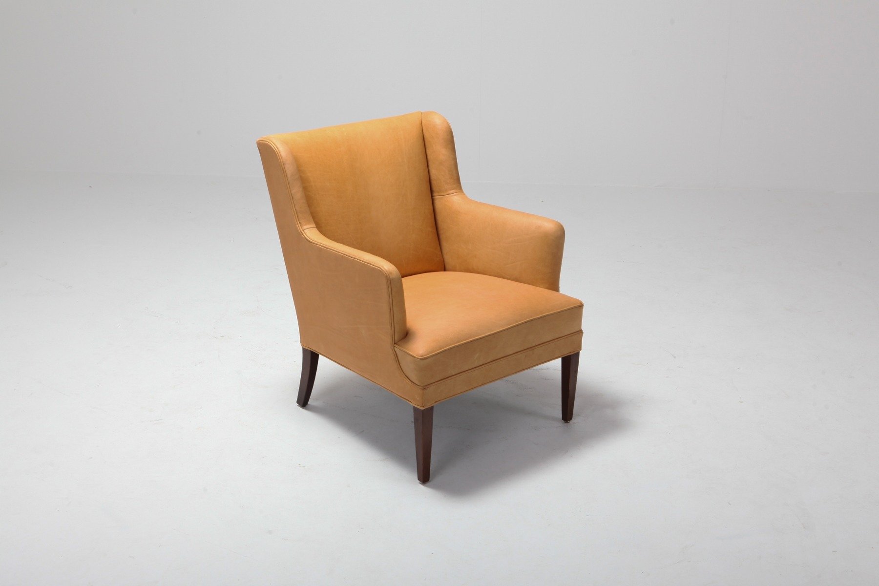 Collectible camel leather bergere chairs from the 1960s