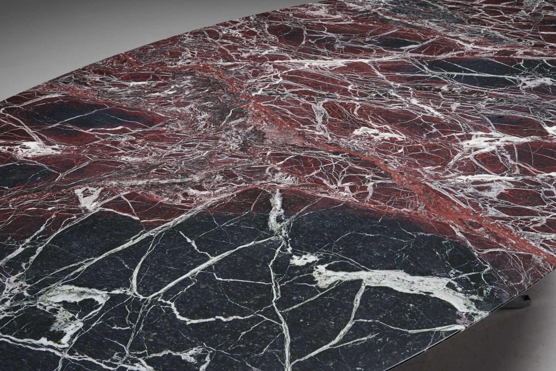 Collectible marble table by Florence Knoll in burgundy tone