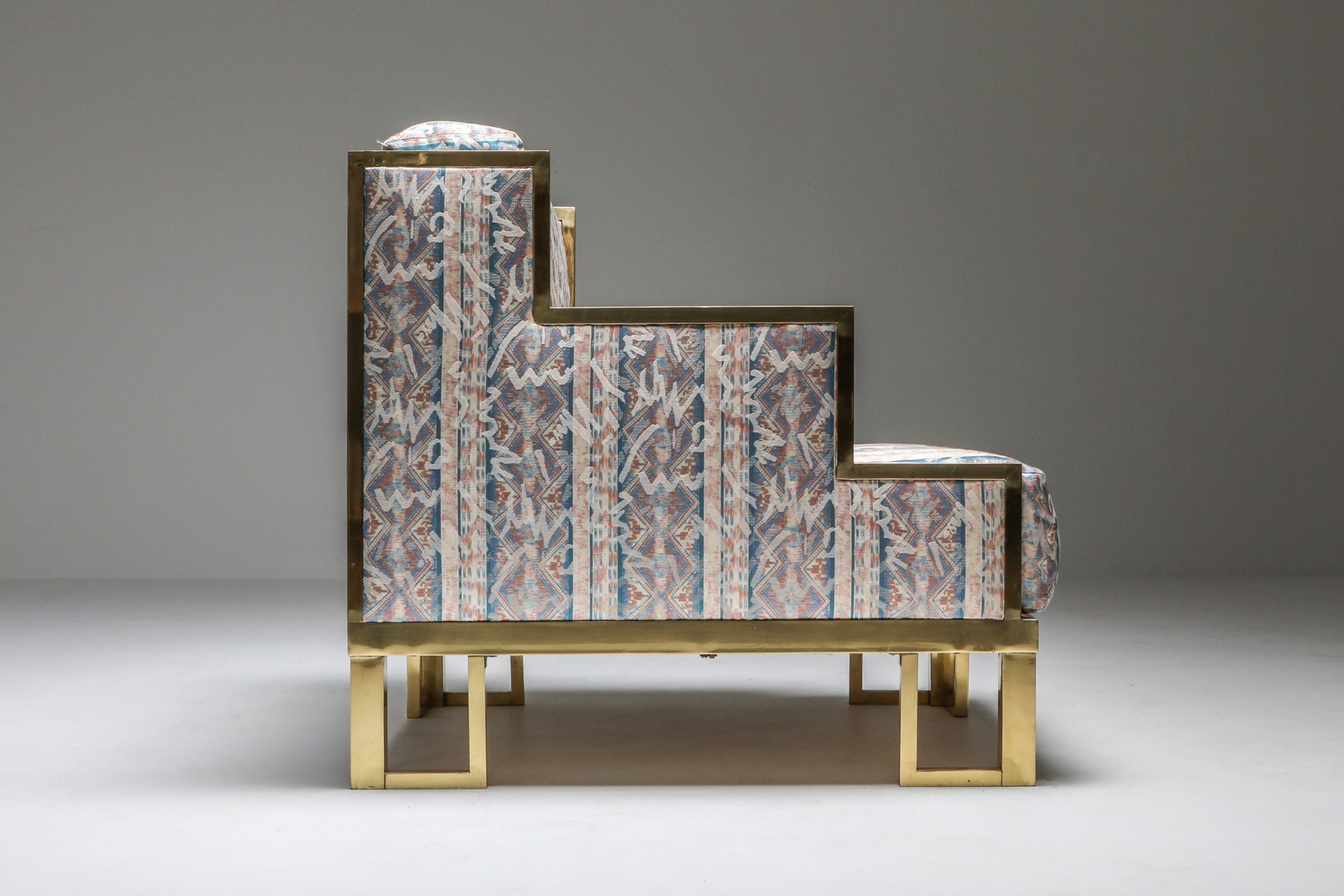Designer brass lounge chair and ottoman from the 1970s
