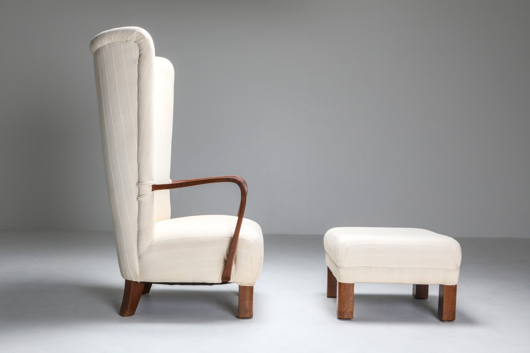 Designer wingback chair with ottoman in 1950s style