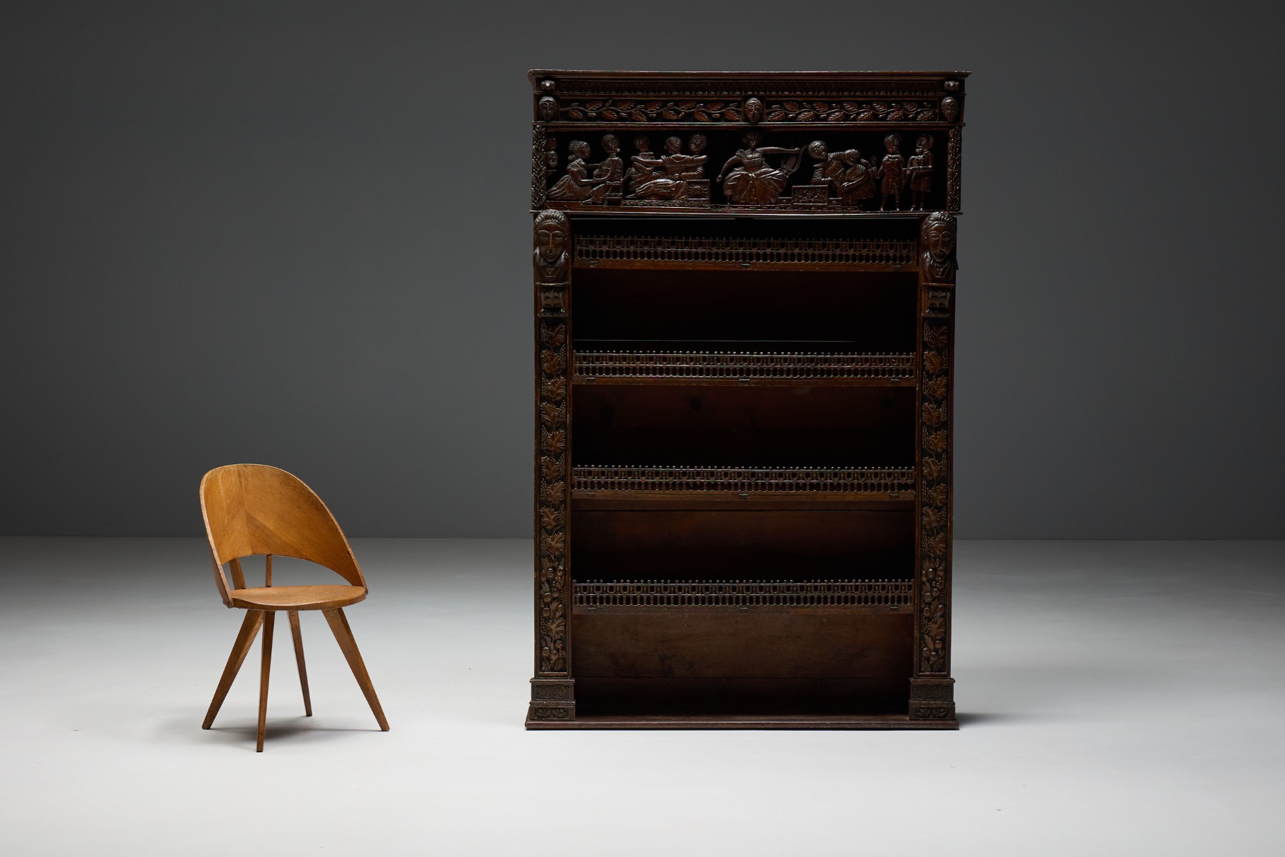 Expressive antique carved bookcase in wood with figurative and vegetal motifs, 19th century 