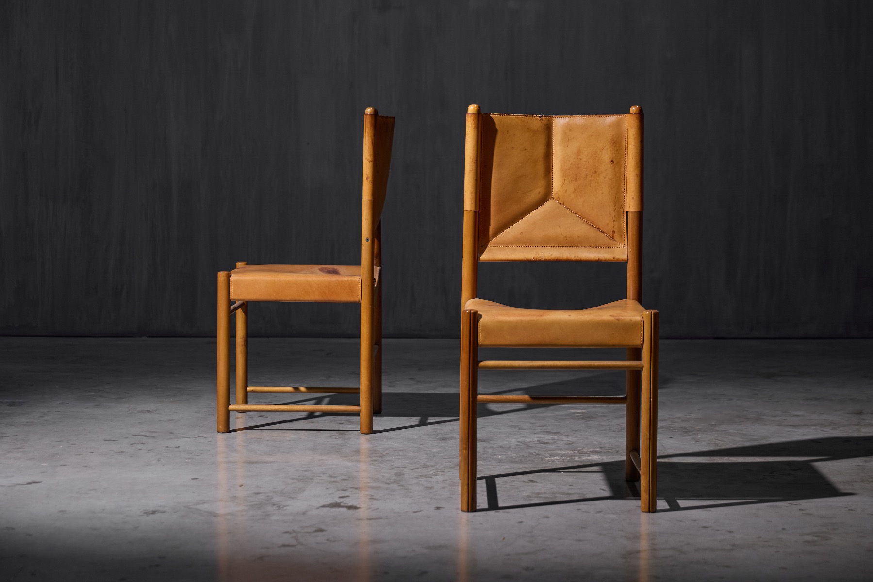 Authentic 1960s leather dining chairs with sleek frame