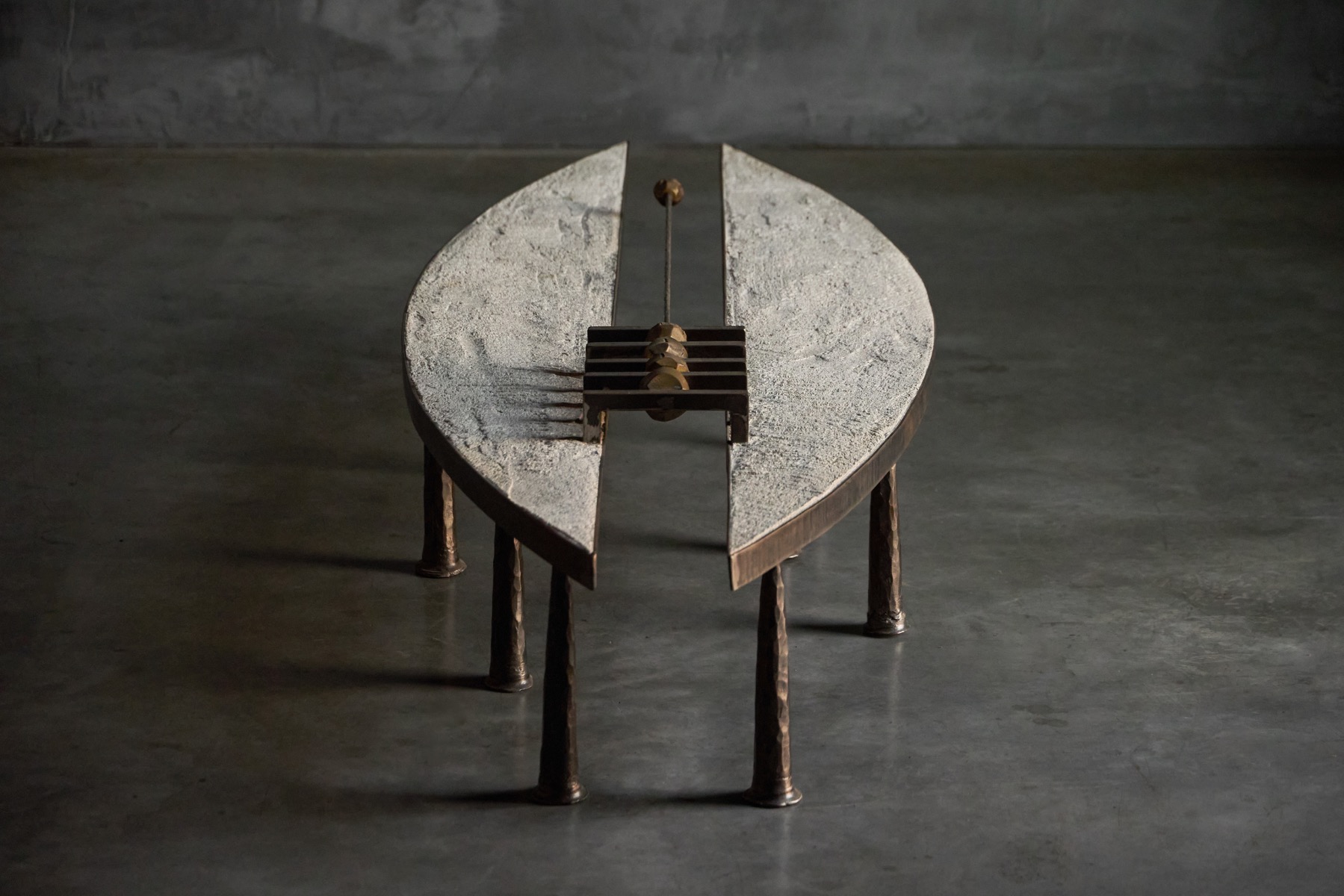 Brutalist coffee table featuring steel structure and stone top by Thomas Serruys