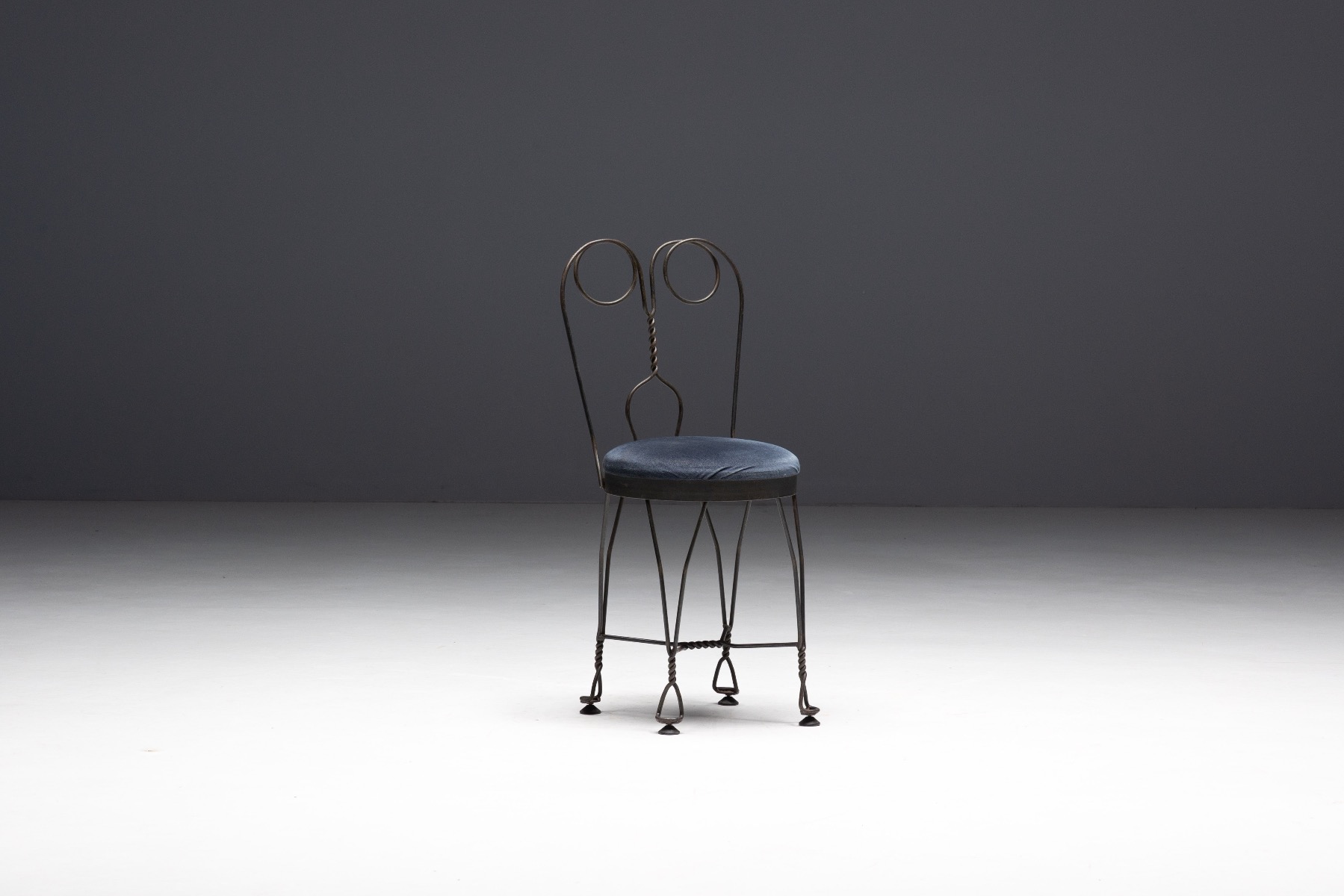 Architectural butterfly chair with forged iron structure