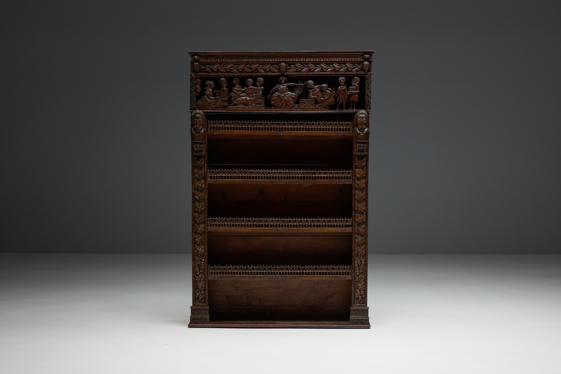 French antique bookcase from the 19th century with rich carved ornamentation