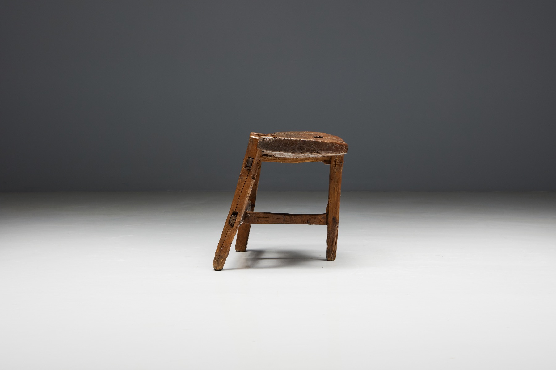 Sculptural tripod bench in natural wood