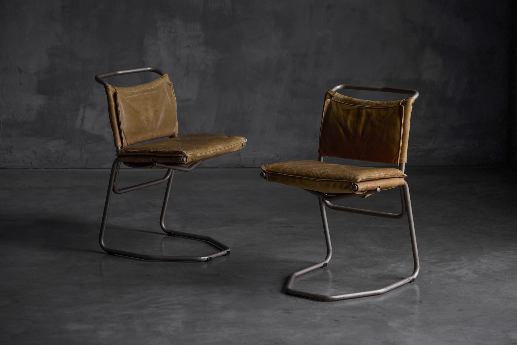 Minimalist dining chairs combining leather and steel materials
