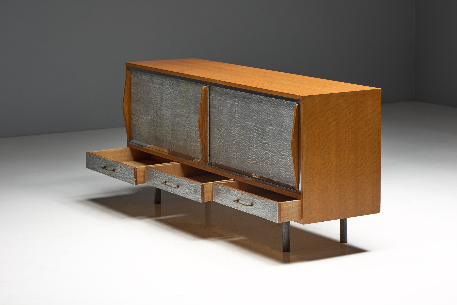 Textured hammered metal sideboard reflecting 1960s design