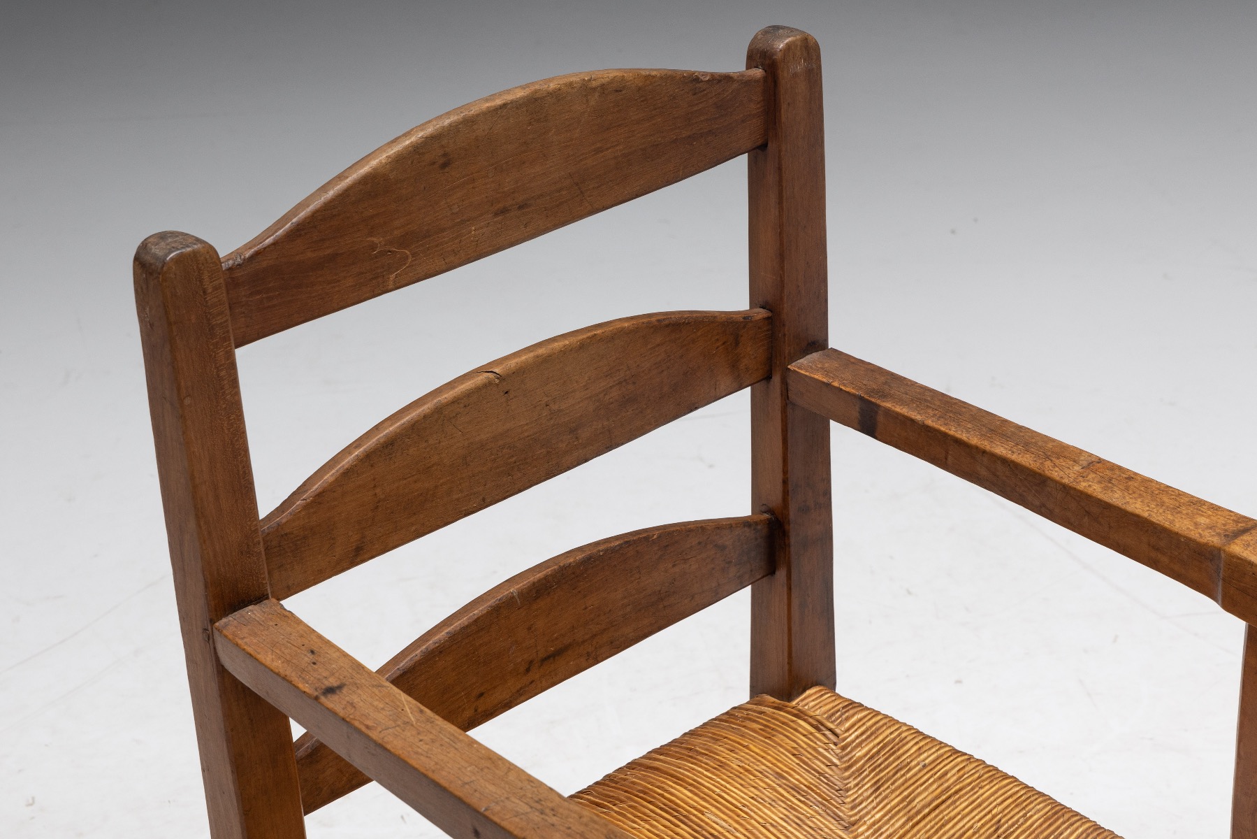 Traditional wooden armchair with woven seat design