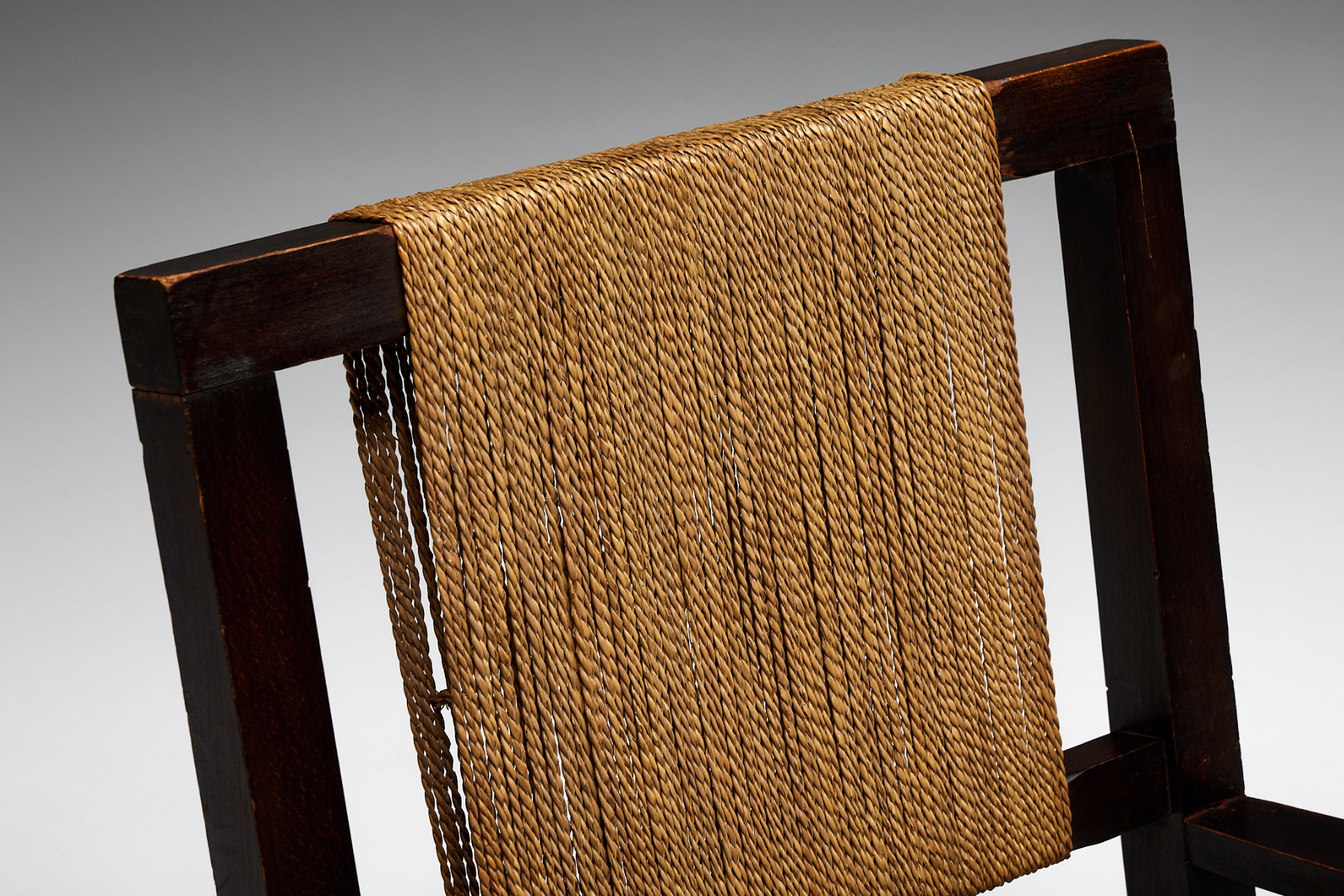 Traditional wooden chair with woven rope design