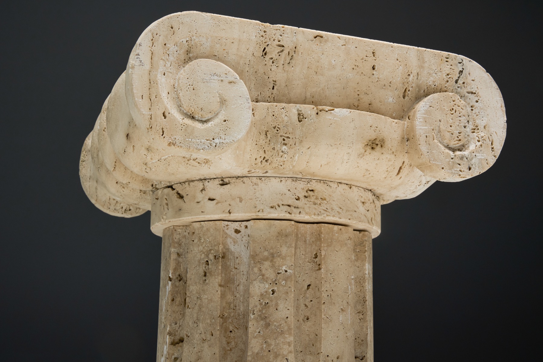 Ionic capital travertine side table reinterpreting classical architecture  