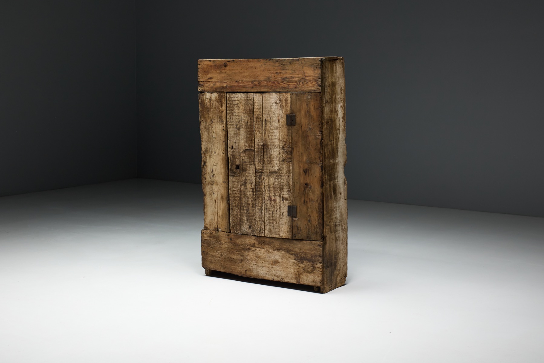 Aged wood cabinet in Art Populaire style with authentic patina and grain