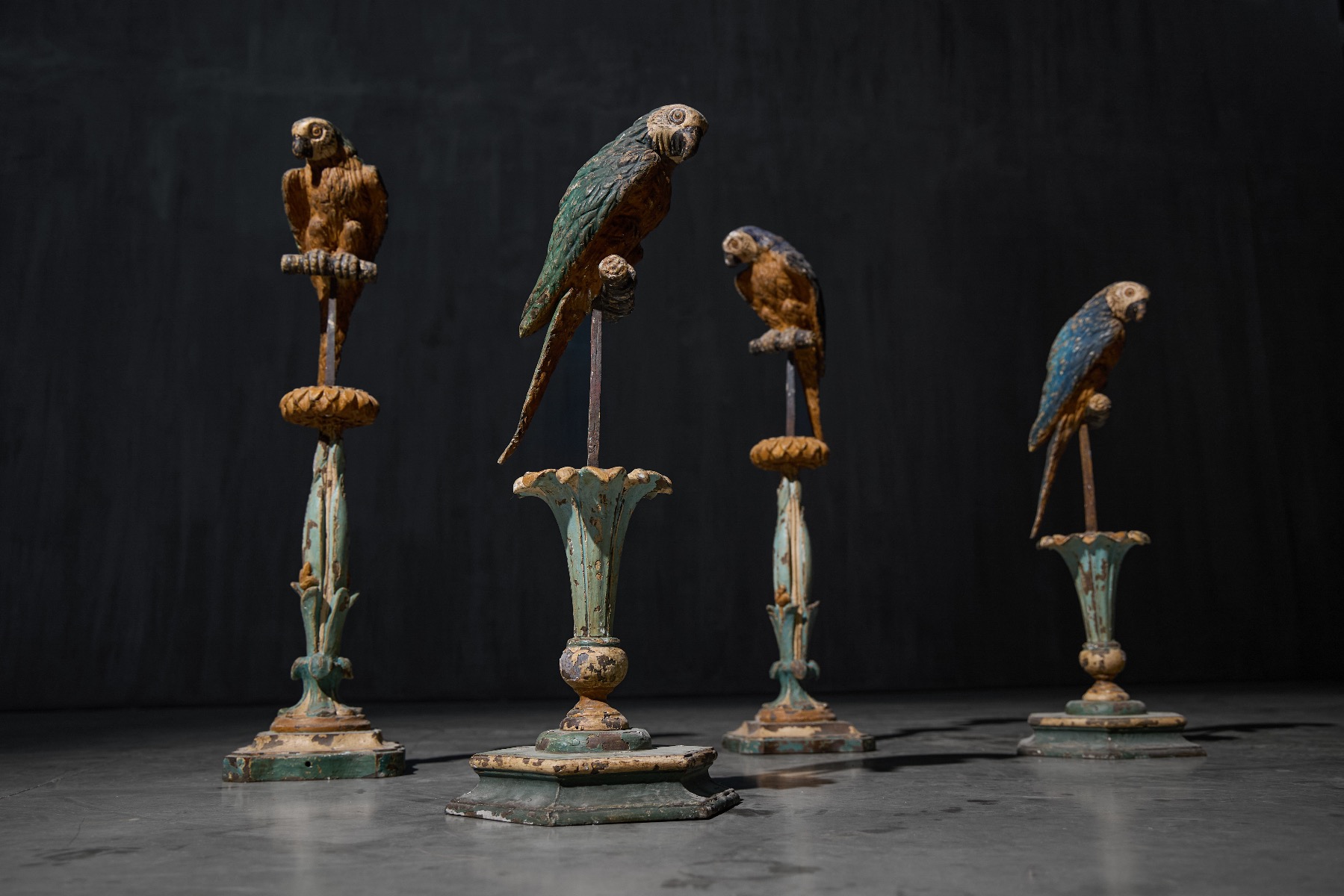 Antique ornamental parrots presented on pedestals