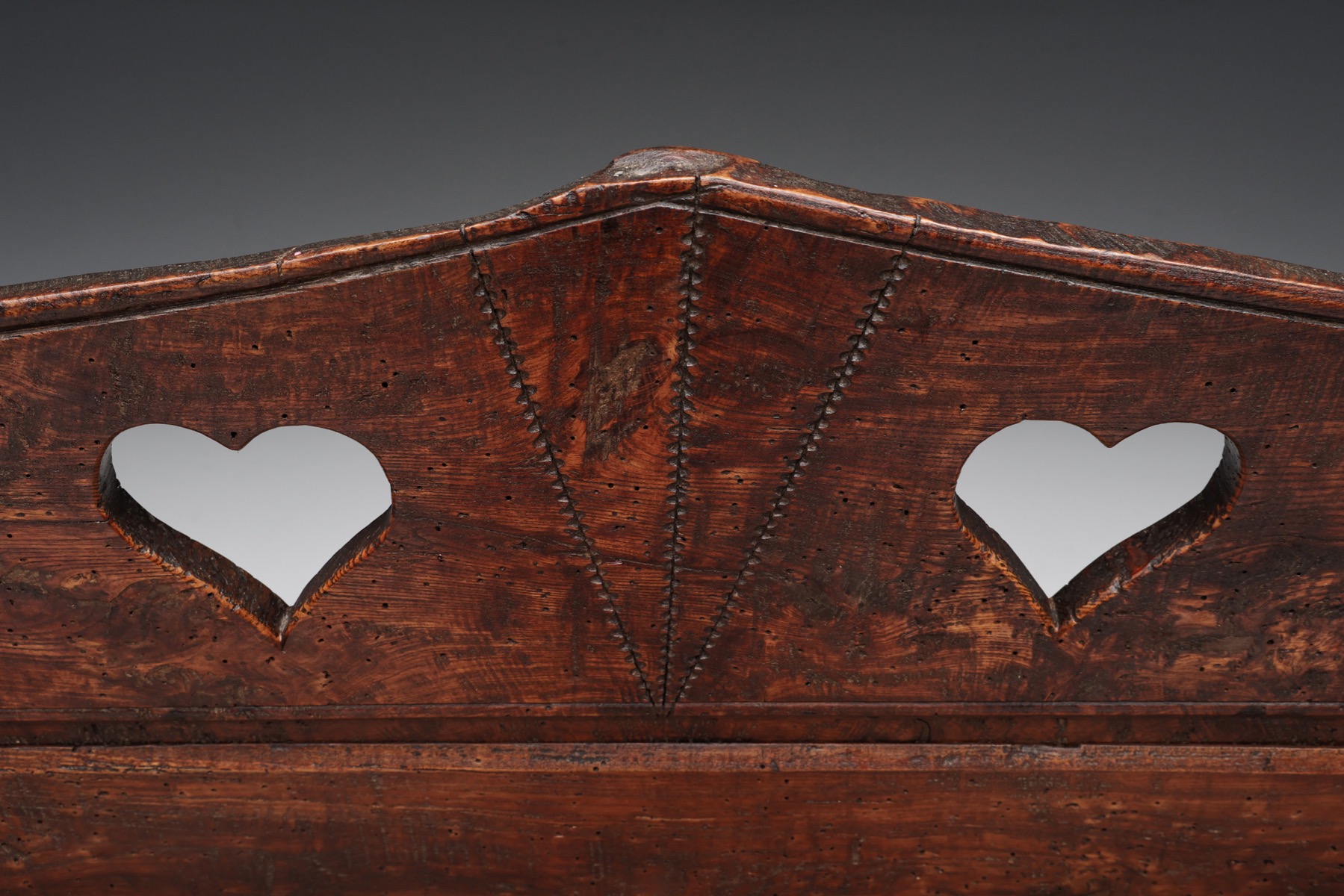 Antique rustic bench with carved storage design