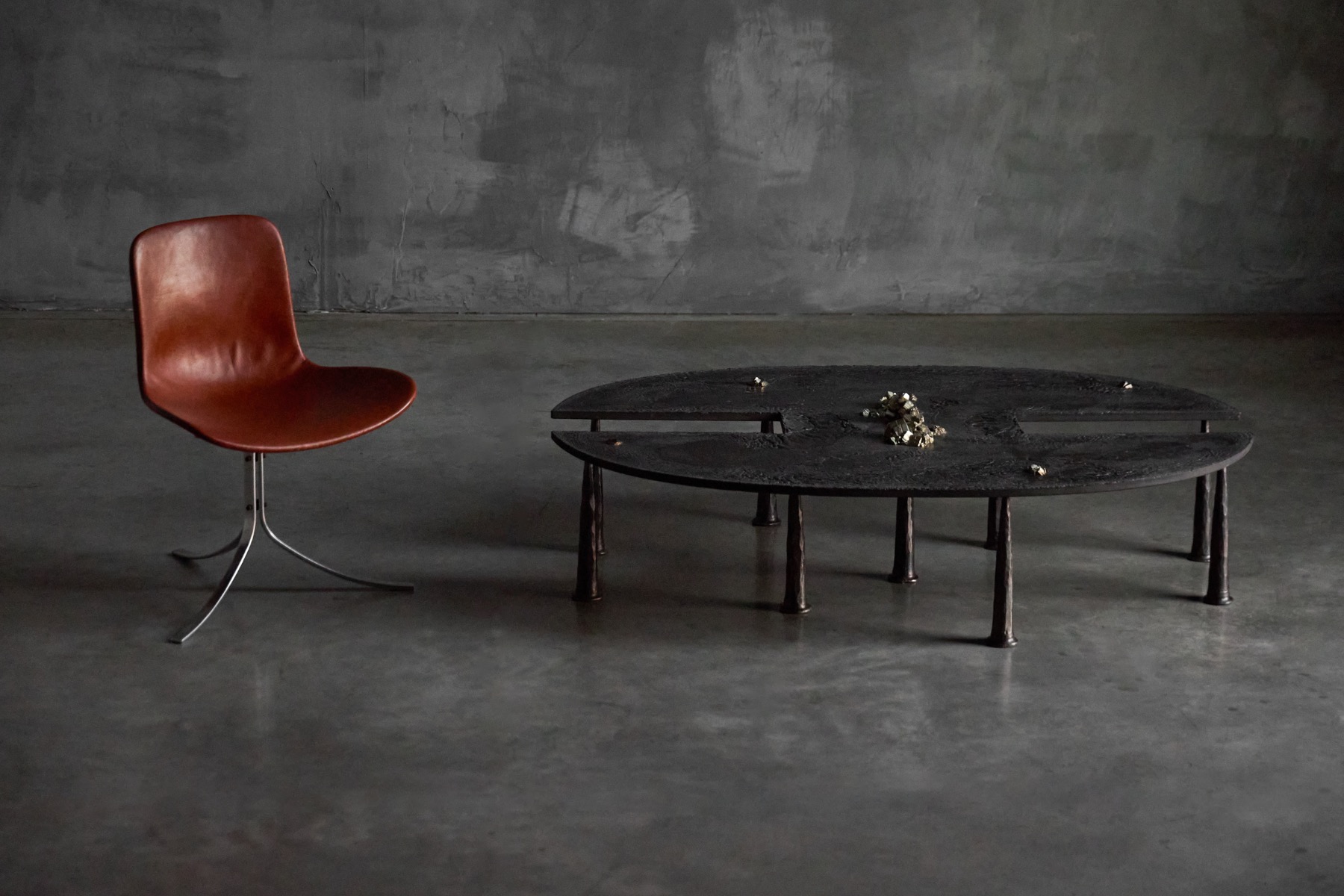 Iron coffee table with raw mineral texture designed by Thomas Serruys