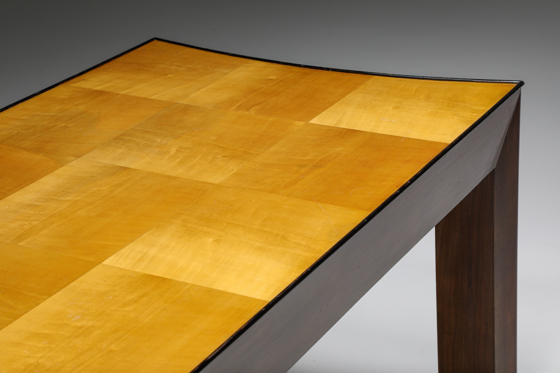 Sleek concave dining table in retro art deco style