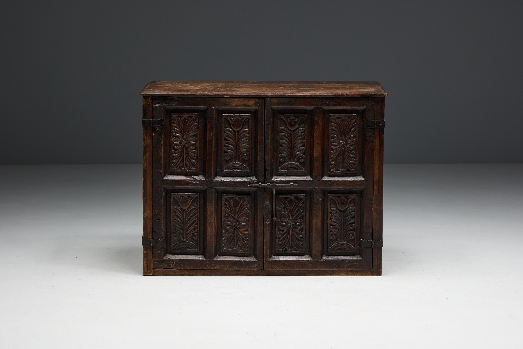 Aged wood carved cupboard with authentic wear