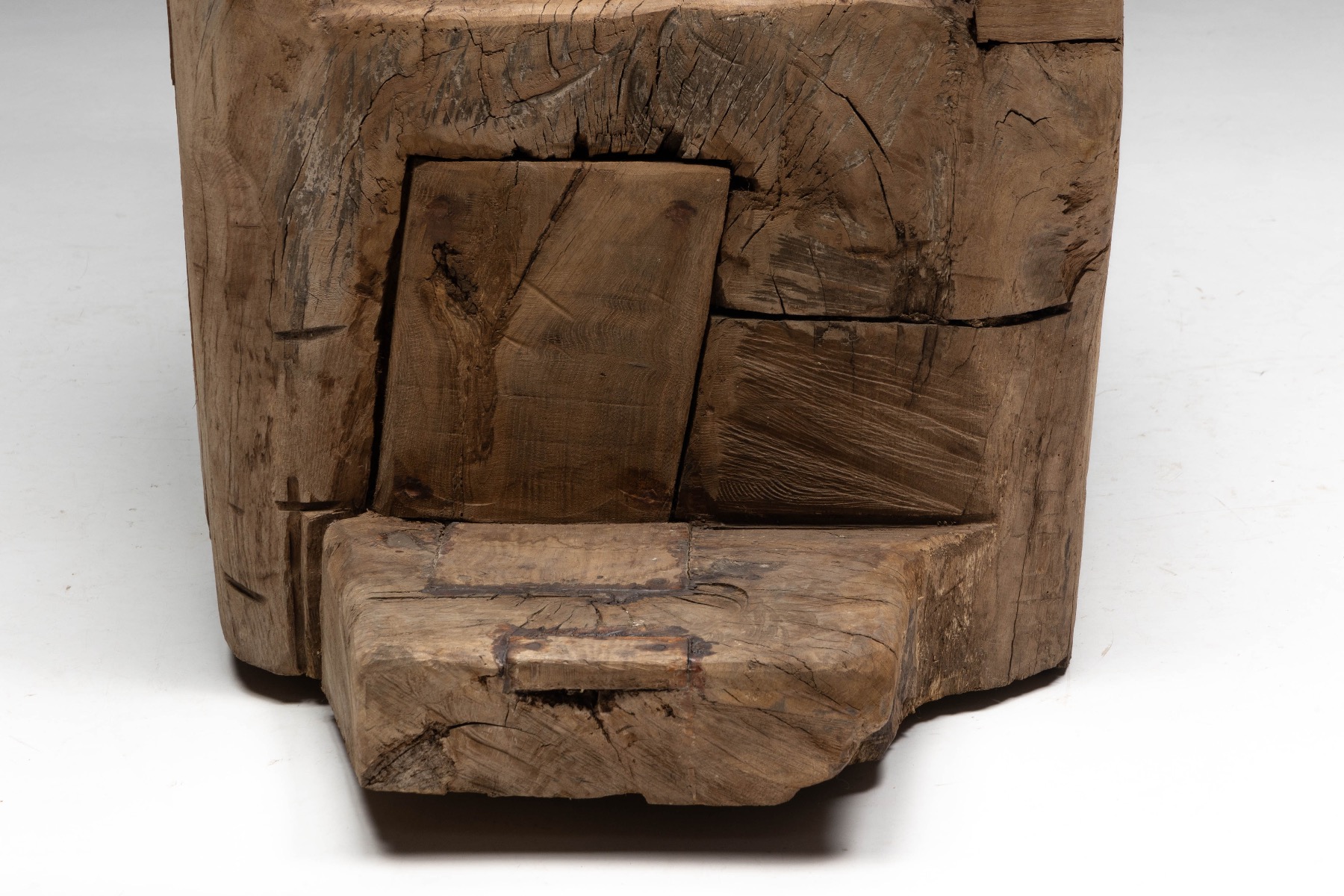 Archaic brutalist throne chair with raw wood surface
