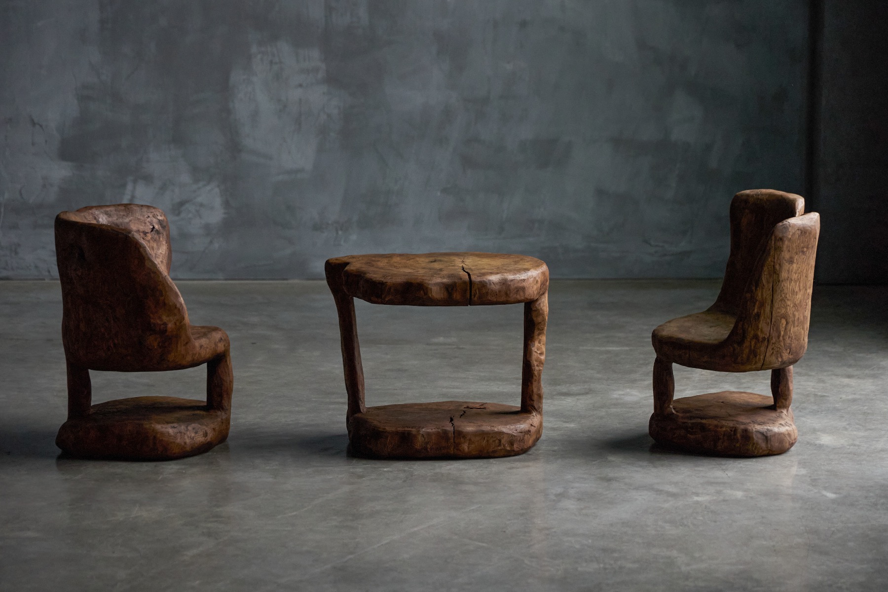Rustic brutalist chairs carved from single blocks of wood