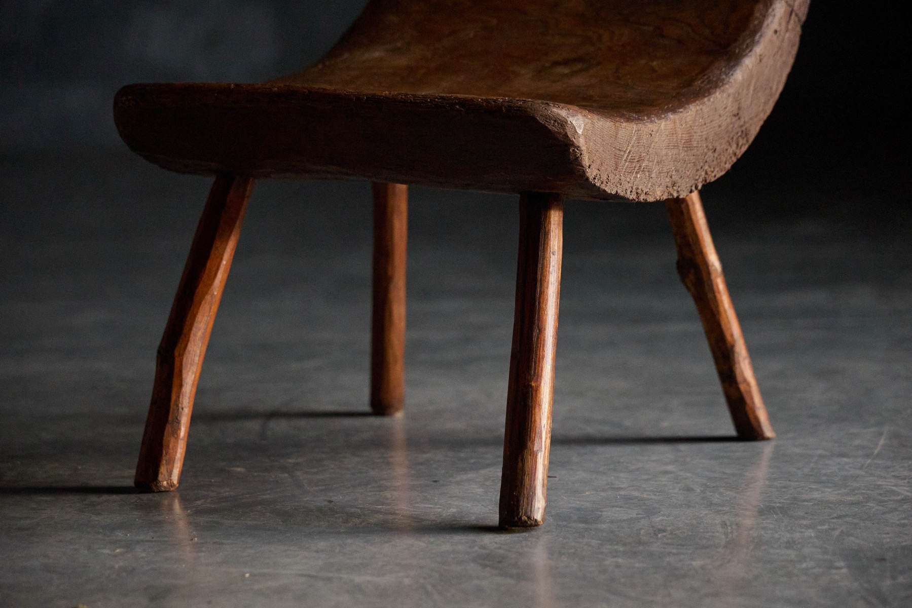 Sculptural monoxyle stool in aged wood