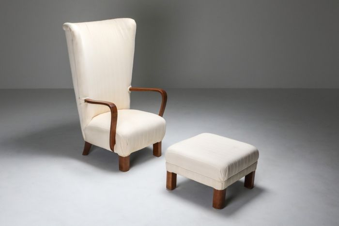 White wingback chair with ottoman from the 1950s